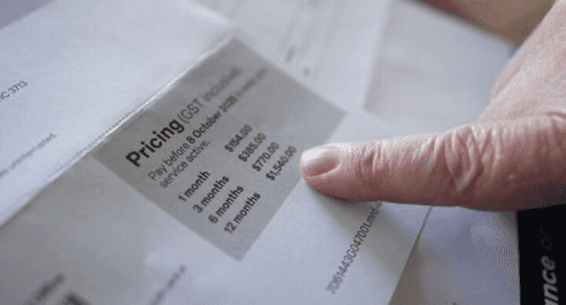 A Melbourne resident points to a postal bill showing an unexpected $1,500 charge caused by an Australia Post system error in October 2025.